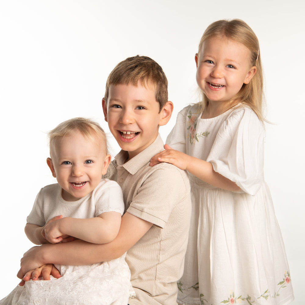 Colour Portrait of three young children dressed in white by PHOTOGENIC Dalkey