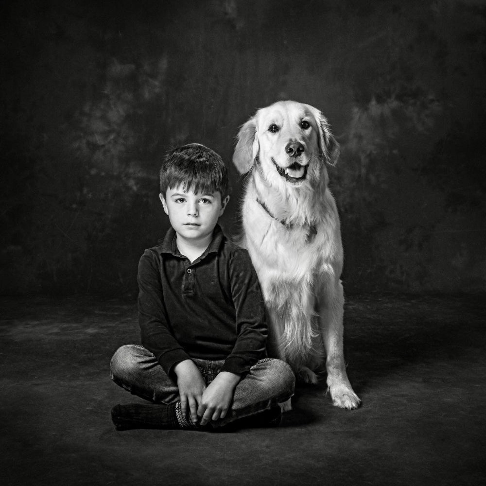 Portrait in black and white of a little boy and his golden Retriever dog sitting side by side  PHOTOGENIC Dalkey