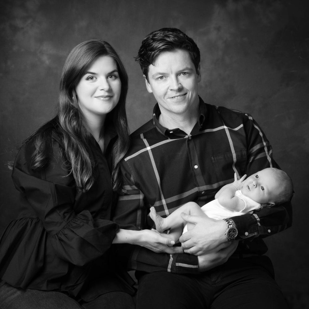 Black and white portrait of a family with a baby against a dark background
Family portrait session PHOTOGENIC Dalkey Dublin