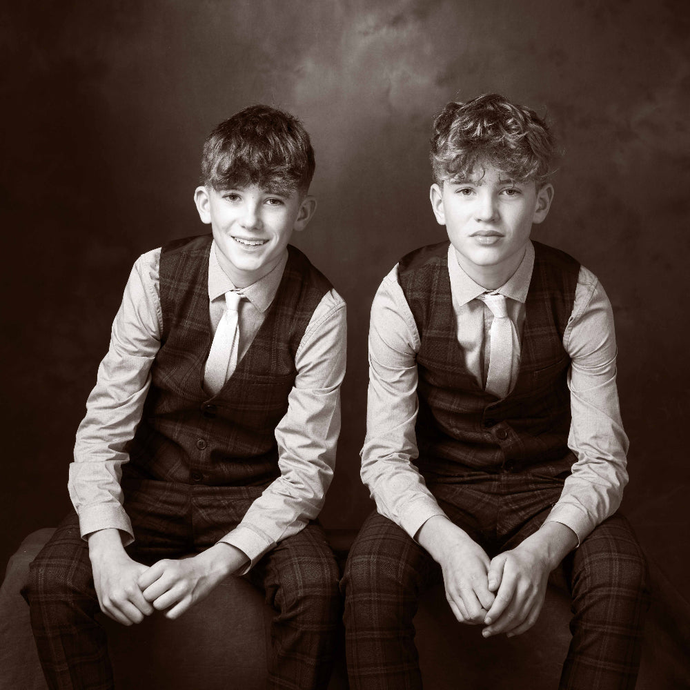 Two young boys in formal attire sitting side by side against a dark background
Children’s portrait session PHOTOGENIC Dalkey Dublin