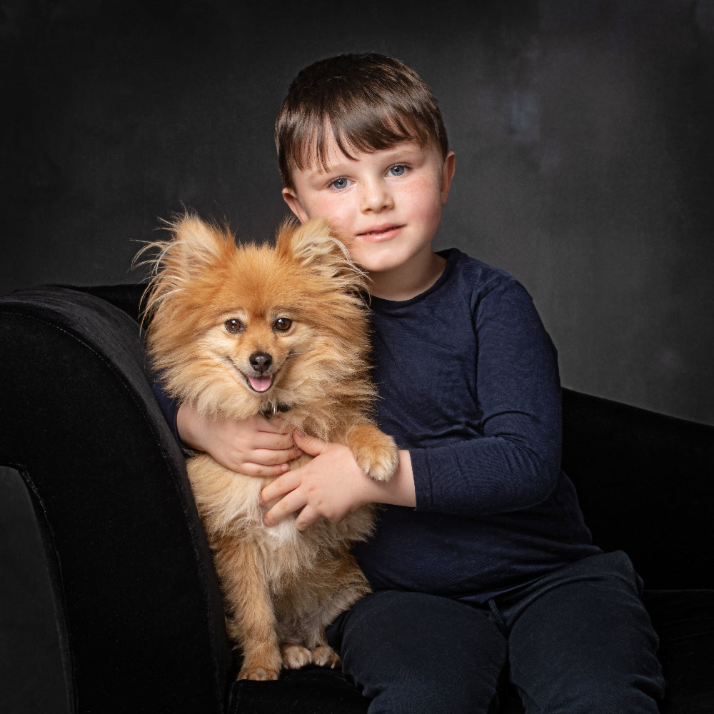 Portrait in colour of a little boy and his small golden Pomeranian dog PHOTOGENIC Dalkey
