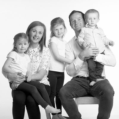 Portrait in black & white of a family of two parents and three young children